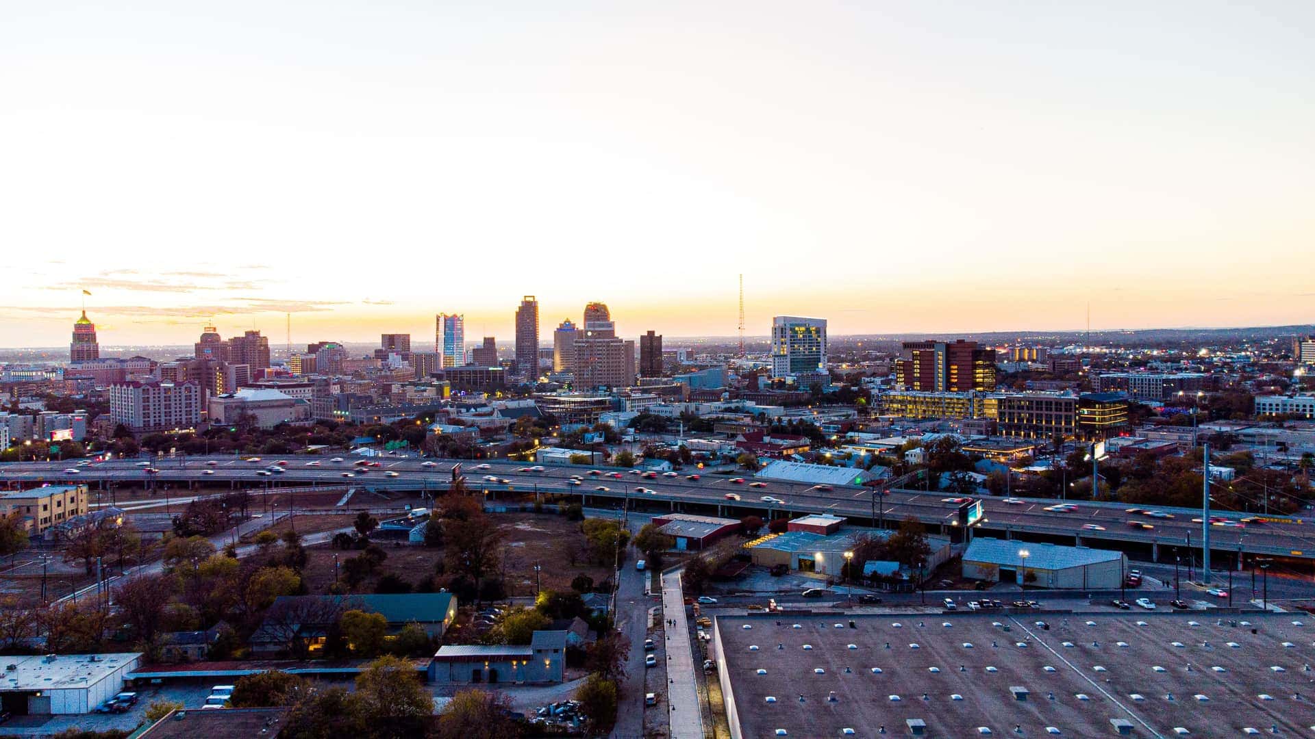 Downtown San Antonio at sunset, the Tower Life dome and Frost Tower above the interstate