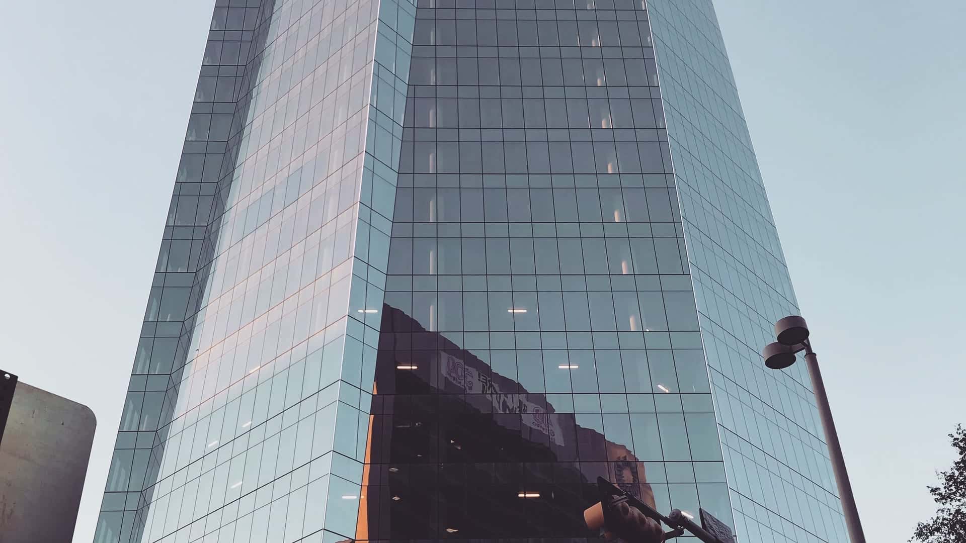 A downtown San Antonio glass high-rise at dusk on Houston Street